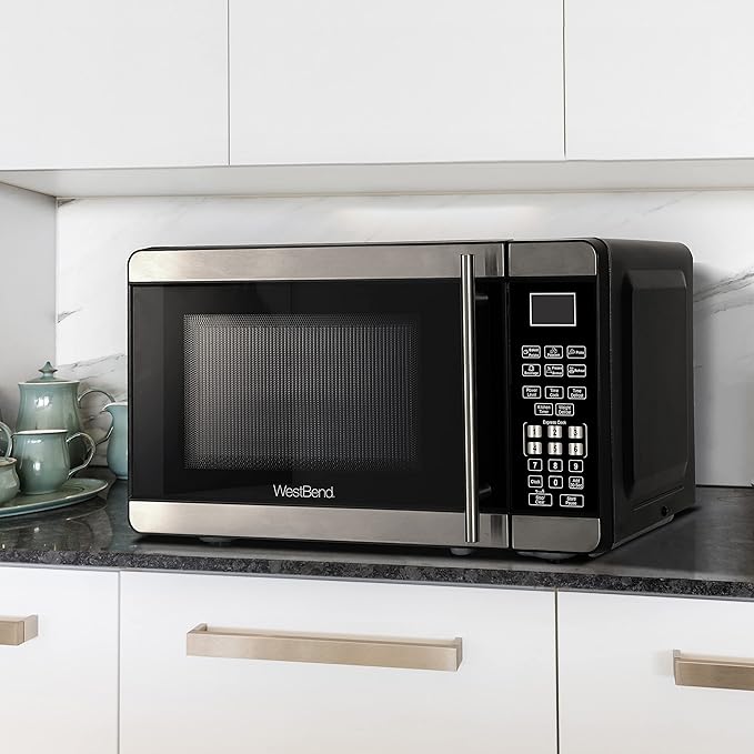 West Bend Microwave Oven 700-Watts Countertop Compact Footprint with 6 Pre Cooking Settings, Speed Defrost, Electronic Control Panel and Glass Turntable Perfect for Small Spaces, 0.7-Cu.Ft., Metallic